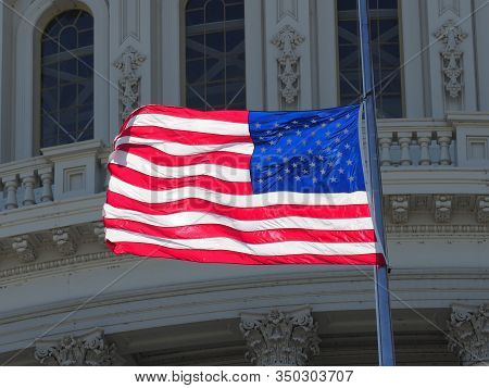 American Flag Half-mast On Top Of The Capitol.