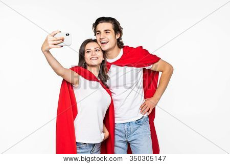 Young Couple Hero In Red Cout Take Selfie On The Phone Isolated On White Background