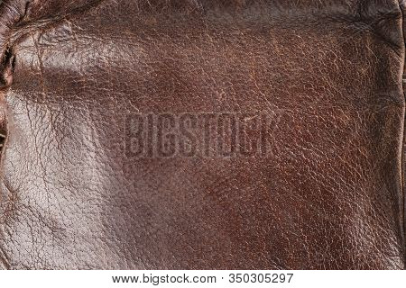 Brown Background-leather Fabric, Close-up Leather With A Reddish Tint. Old, Stylish, Worn. Beautiful