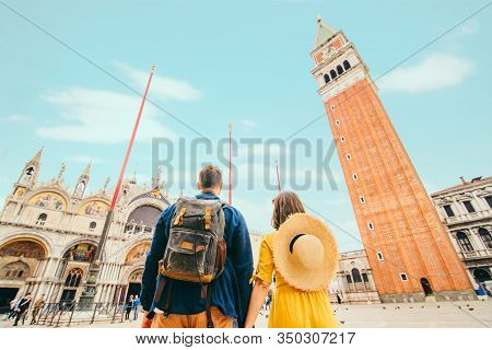Rear View Of Couple Holding Hands At Saint Marks Square Venice Italy