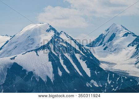 Atmospheric Minimalist Alpine Landscape With Massive Hanging Glacier On Snowy Mountain Peak. Big Bal