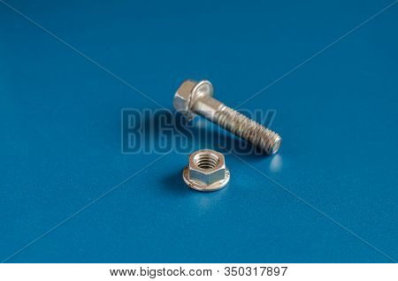 Bolt And Nut On A Blue Background. Bolt And Nut On A Blue Background.  Close-up Nut With Skirt And U