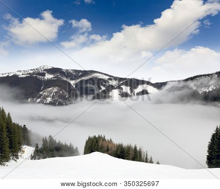 winter landscape in mountains with fog in valley. Slovakia, West Tatras, Spalena ski resort.