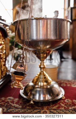 A Priests Censer Hangs On An Old Wall In The Orthodox Church. Copper Incense With Burning Coal Insid