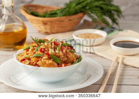 Tori Chahan Fried Japanese Rice With Vegetables And Chicken In Soy Sauce In A Black Plate On A Woode