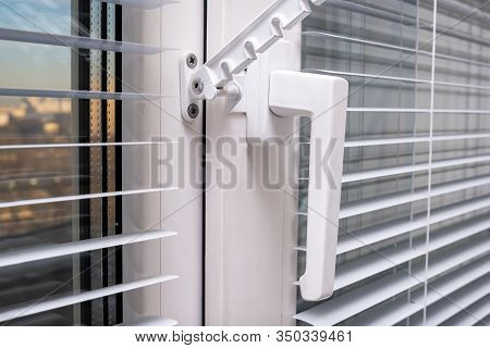 A Handle And A Restrictor, Window Stopper Or Limiter On Pvc Double Glazed Window With Horisontal Alu