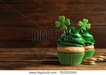 Delicious Decorated Cupcakes On Wooden Table, Space For Text. St. Patrick's Day Celebration