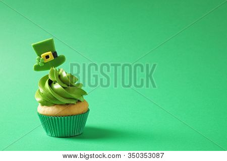 Delicious Decorated Cupcake On Green Background, Space For Text. St. Patrick's Day Celebration