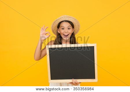 Publicity And Education. Happy Child Give Ok Sign. Little Kid Hold Blank Blackboard. School Publicit