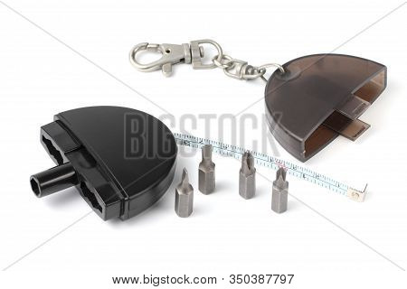 Compact Rulette And Screwdriver Bit Set Close-up, White Background.