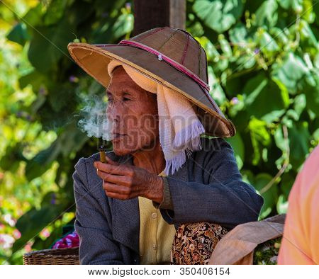 Heho, Myanmar - Nov 08, 2019: Smoking Woman At A Market In The City Center Of Heho In Myanmar, Forme