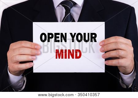 Businessman Holding A Card With Text Open Your Mind