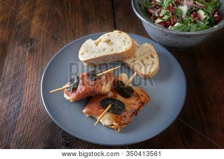 Roasted Chicken Saltimbocca Wrapped With Prosciutto Ham And Sage Leaves Served With Bread And Salad 
