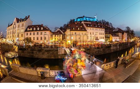 View Of Lively River Ljubljanica Bank In Old City Center Decorated With Christmas Lights At Dusk. Ol