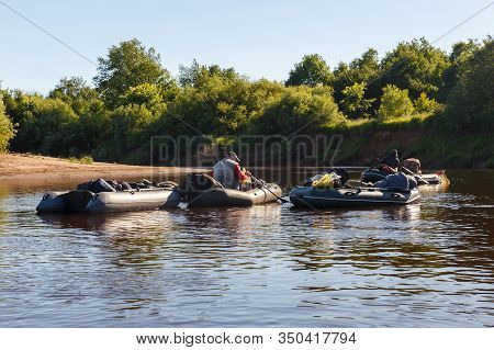 Several Rubber Fishing Boats Float Down The River. Pizhma River.