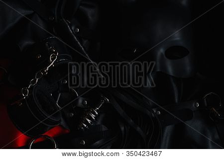 Set Of Accessories For Bdsm Sex With Domination And Submission. Leather Whip Flogger, Handcuffs And 