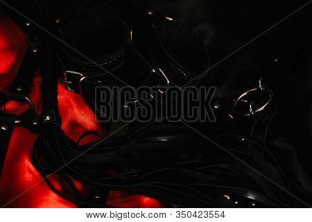 Whip Flogger, Leather Handcuffs And On Red Silk, Kinky Sex Toys For Dom Sex Games And Other Forms Of