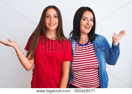 Young beautiful women wearing casual clothes standing over isolated white background smiling showing both hands open palms, presenting and advertising comparison and balance