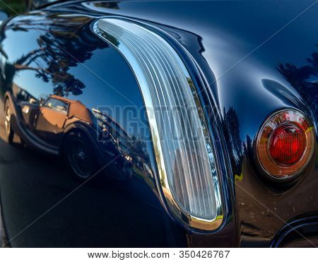 Old classic car   reflected in the bodywork of another classica car
