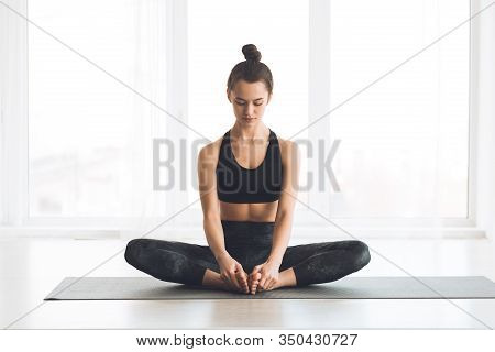 Pilates. Calm Girl Working Out Doing Yoga Exercise, Sitting In Baddha Konasana, Bound Angle Or Butte
