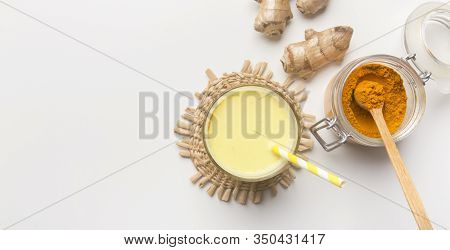 Food And Drink, Diet Nutrition. Organic Orange Turmeric Root And Powder, Mandeln Milk On White, Pano