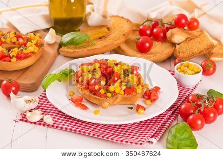Friselle With Tomatoes And Mais On White Dish.