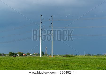 Power Lines Crossing A Rural Landscape Between Haarlem And Amsterdam, The Netherlands
