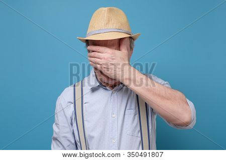 Senior Man In Summer Hat Covering Eyes