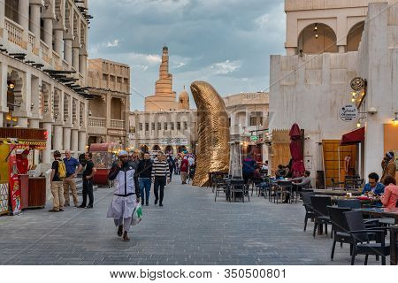 Doha,qatar-february 10,2020: Souk Waqif Doha, Qatar Main Street Daylight View  With The Thumb Monume