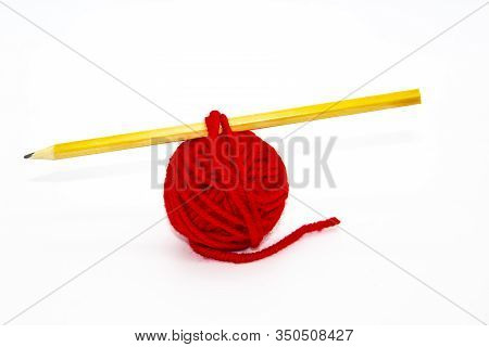 Red Skein Of Thread With The Pencil Against White Background. Red Ball Of Woollen Red Thread Isolate