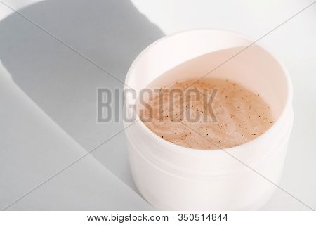 Flat Lay With Scrab Mask In Jar. Beauty Background With Facial Cosmetic Products. Spa Concept. Beaut