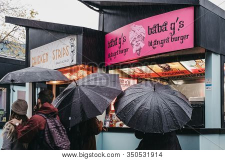 London, Uk - November 26, 2019: People Ordering Take Away Food Under The Rain From Baba Gs Stall Cam