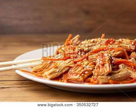 Close-up Spicy Chinese Or Korean Yuba Tofu Bamboo And Carrots Salad On Wooden Background