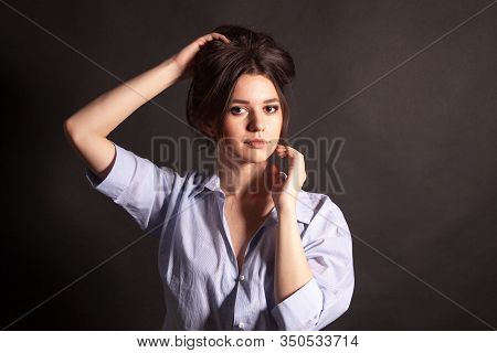 Portrait Of Beautiful Young Woman In A Blue Shirt. Sensual Girl With Make-up.
