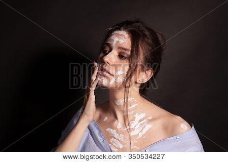 Fashion Beauty Portrait Of Beautiful Young Brunette Woman. White Paint On The Body And Face.