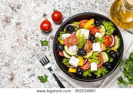Greek Salad. Vegetable Salad With Tomato, Cucumber, Salad Leaves, Feta Cheese And Olive Oil. Top Vie