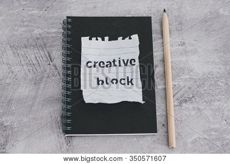 Scrunched Paper With Creative Block Text On Desk With Notepad, Lack Of Inspiration