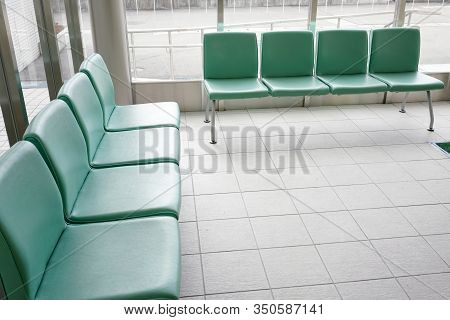 Hospital Waiting Room With Empty Green Chairs