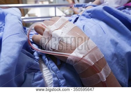 Patient Hand With The Tube Of Normal Saline Infusion.asian Patient With Iv Solution Healthcare And M