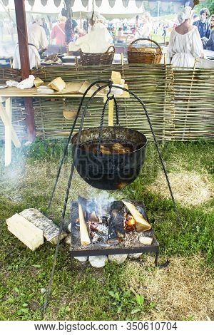 Moscow/ Russia - 16.06.2019: A Large Antique Vat With Meat Soup Is Cooked At The Stake Amid People I