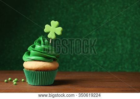Delicious Decorated Cupcake On Wooden Table, Space For Text. St. Patrick's Day Celebration
