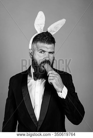 Easter Bunny Man Nibbles A Carrot Like A Hare. Healthy Man On Holiday. Easter Copy Space. Happy East
