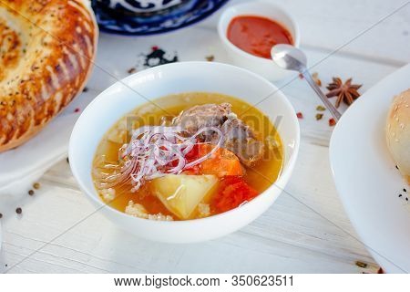 Uzbek Chorba - Soup From Fresh Meat And Vegetables On White Table.
