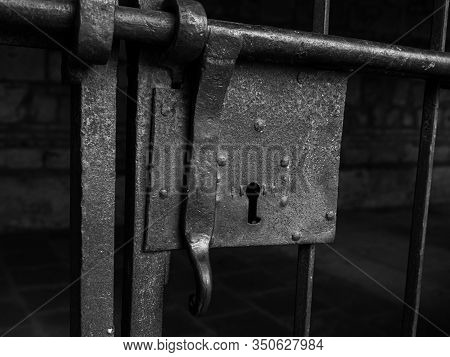 Black And White Photo Of A Detail Of An Iron Lock Of A Barred Door In An Old Stone Building In Mader