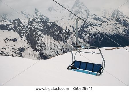 Ski Chair Lift Ropeway At The Ski Resort, View From The Funicular To The Mountains