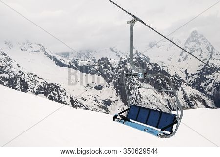 Ski Chair Lift Ropeway At The Ski Resort, View From The Funicular To The Mountains