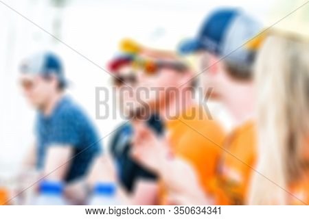 A Group Of Young People Have Fun And Drink Together At A Race Festival (orange Dutch Racing Fans, Su