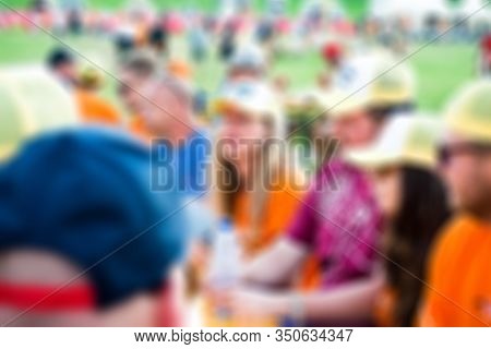 A Group Of Young People Have Fun And Drink Together At A Race Festival (orange Dutch Racing Fans, Su