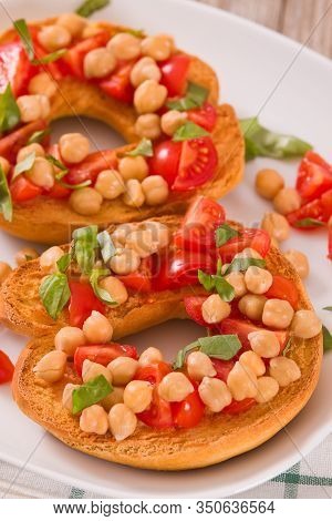 Friselle With Tomatoes And Chickpeas On White Dish.
