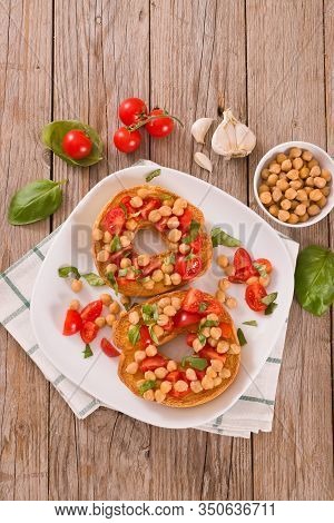 Friselle With Tomatoes And Chickpeas On White Dish.